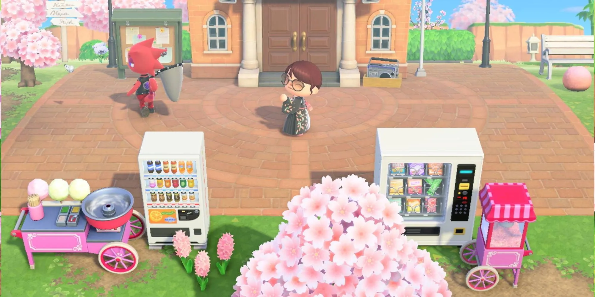 Dân làng nhảy múa trước Tòa thị chính cùng máy bán hàng tự động trong Animal Crossing New Horizons.
